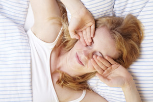 Woman rubbing her eyes after waking up